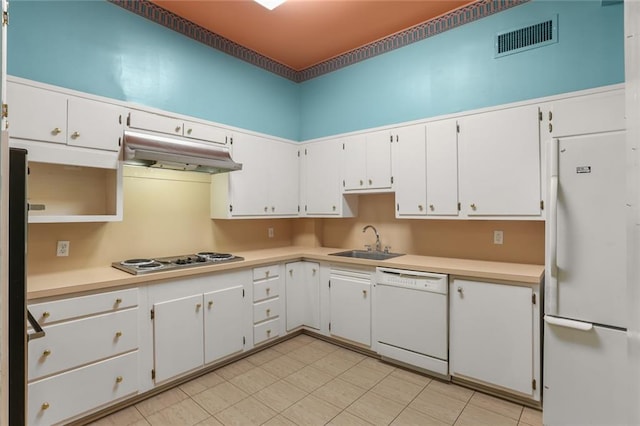 kitchen featuring white appliances, sink, and white cabinets