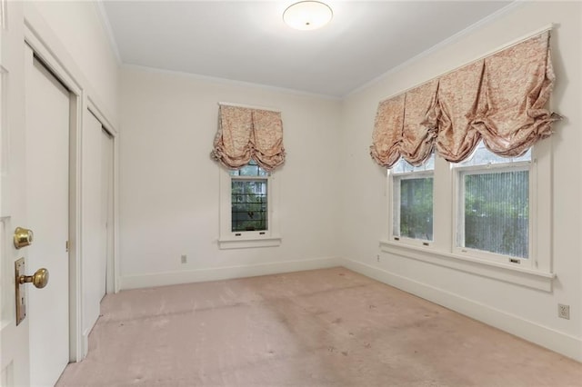 carpeted spare room with crown molding