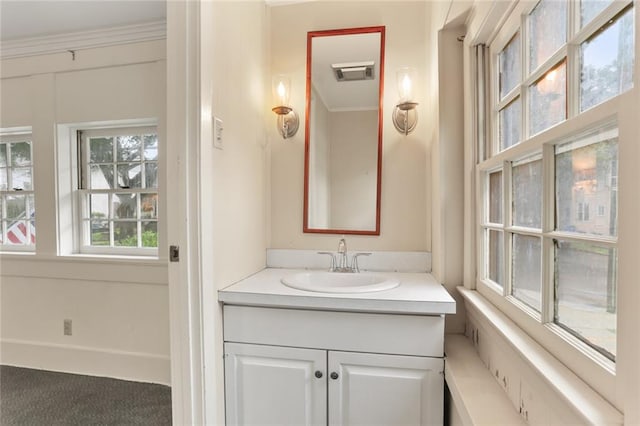 bathroom featuring crown molding and vanity