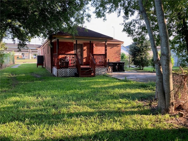 back of house with a yard and a wooden deck