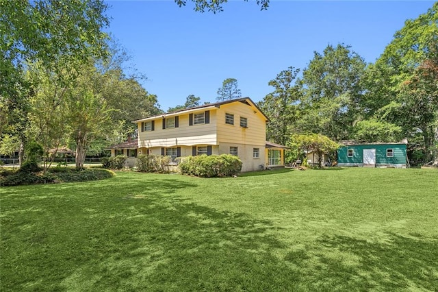 rear view of property featuring a yard