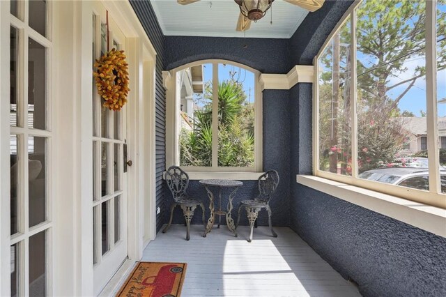 sunroom / solarium featuring a wealth of natural light and ceiling fan