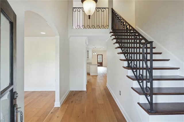 staircase with hardwood / wood-style floors