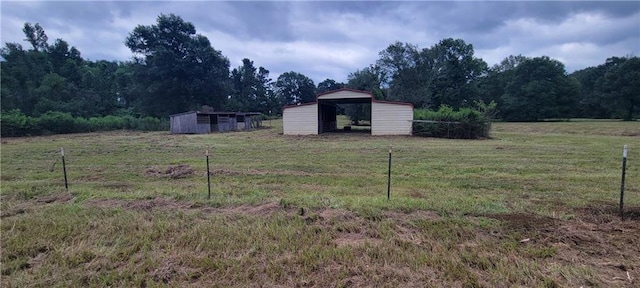 view of yard featuring an outbuilding and a rural view