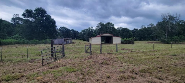 view of yard with a rural view and an outdoor structure