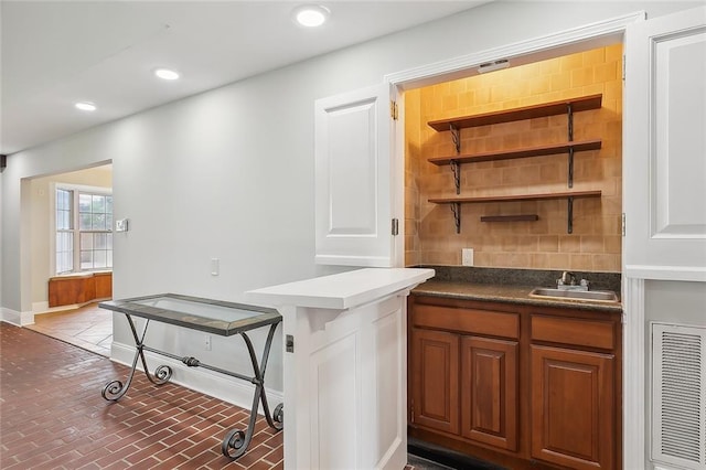 clothes washing area featuring sink