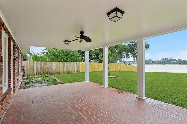 view of patio / terrace featuring ceiling fan and a water view