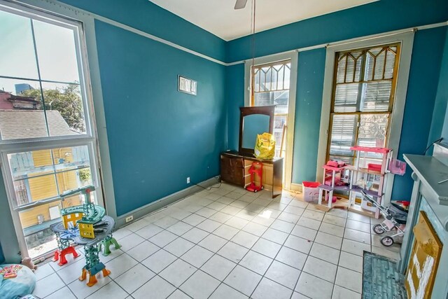 122729 Carondelet St, New Orleans, LA 70130 - recreation room featuring tile patterned flooring, ceiling fan, and baseboards