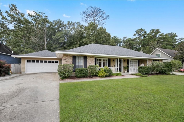 single story home with a garage, a front lawn, and covered porch