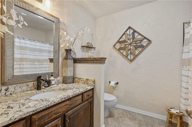 bathroom with toilet and vanity