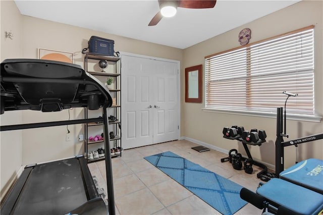 exercise area featuring ceiling fan and light tile patterned floors