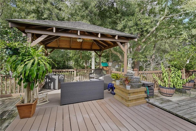 wooden deck with an outdoor living space and a gazebo