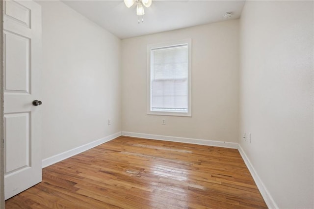 empty room with ceiling fan and light hardwood / wood-style flooring