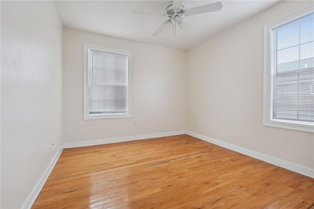 spare room with light wood-type flooring and ceiling fan