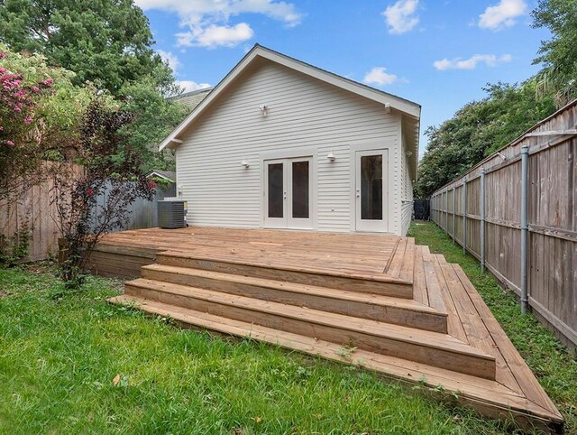 rear view of property with central air condition unit and a wooden deck