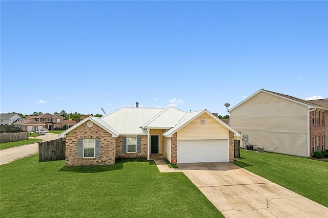 single story home with a garage, fence, a front lawn, brick siding, and concrete driveway