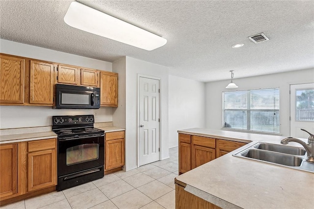 kitchen with a textured ceiling, black appliances, sink, and hanging light fixtures