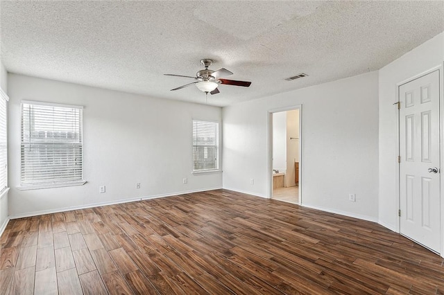 unfurnished room featuring a textured ceiling, dark wood-type flooring, and ceiling fan