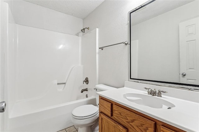 full bathroom featuring toilet, tile patterned flooring, vanity, a textured ceiling, and tub / shower combination