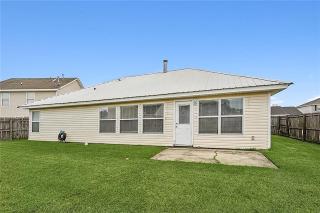 back of house featuring a yard and a patio area