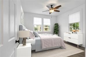 bedroom with hardwood / wood-style floors and ceiling fan