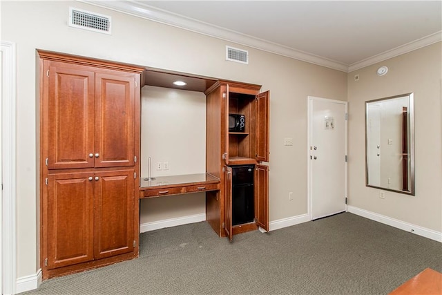 interior space with crown molding and dark colored carpet