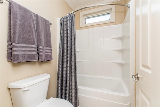 bathroom featuring shower / bath combination with curtain and toilet