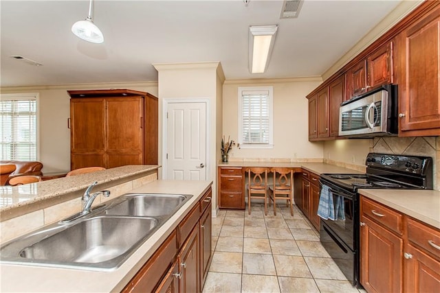 kitchen with pendant lighting, black electric range oven, sink, and plenty of natural light