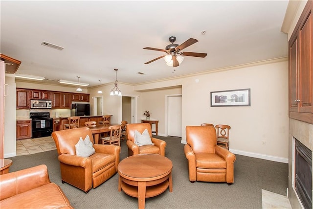 living room with ceiling fan, light colored carpet, a fireplace, and crown molding