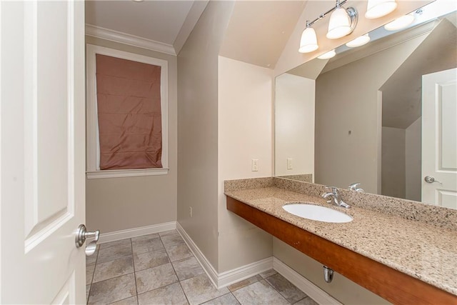 bathroom with lofted ceiling, ornamental molding, vanity, and tile patterned flooring