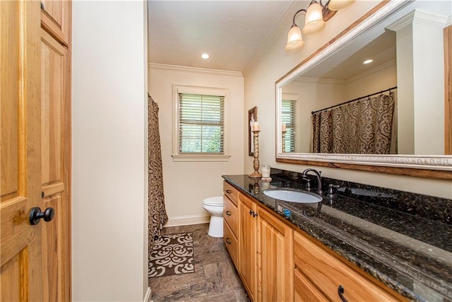 bathroom with crown molding, vanity, and toilet