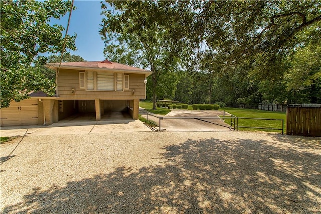 view of home's exterior featuring a lawn and a carport