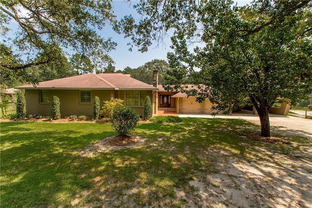 ranch-style house with a garage, a front lawn, a chimney, and driveway