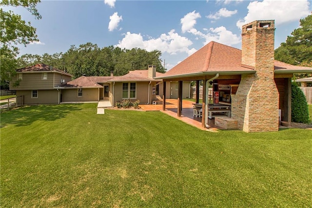 back of property featuring a patio, a chimney, a yard, and fence