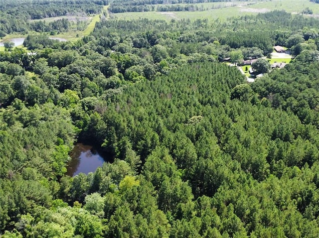 aerial view with a wooded view and a water view