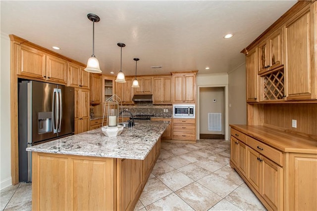 kitchen featuring visible vents, backsplash, under cabinet range hood, light stone counters, and stainless steel appliances