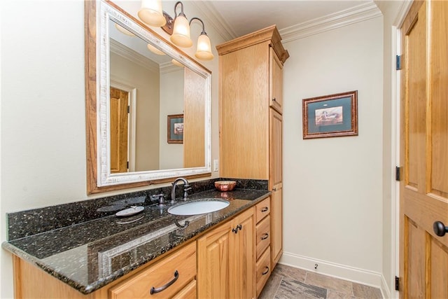 bathroom featuring stone finish floor, vanity, baseboards, and ornamental molding