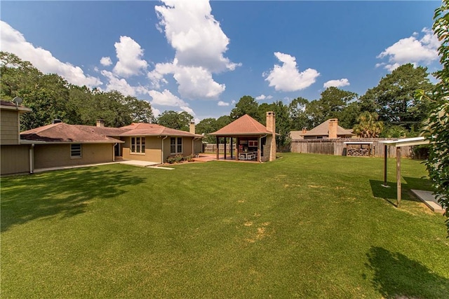 view of yard featuring a patio area, a gazebo, and fence