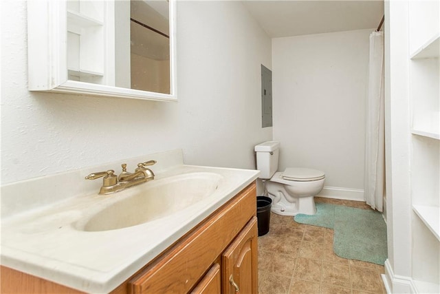 bathroom featuring toilet, vanity, and a shower with curtain