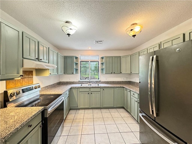 kitchen featuring green cabinets, appliances with stainless steel finishes, a textured ceiling, and sink