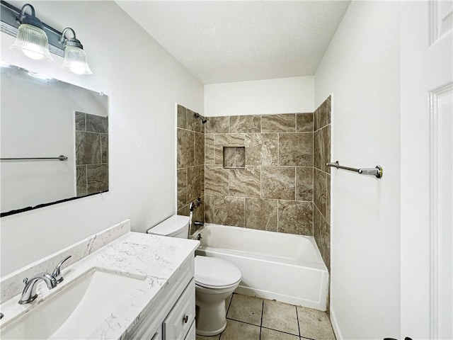 full bathroom featuring toilet, tile patterned flooring, vanity, a textured ceiling, and tiled shower / bath combo