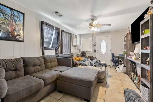 living room featuring crown molding, ceiling fan, and light tile patterned floors