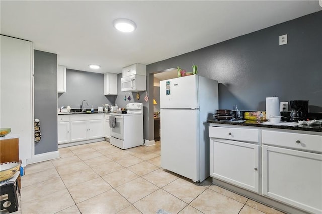 kitchen with white cabinets, white appliances, light tile patterned floors, and sink