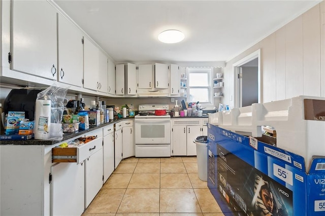 kitchen featuring white cabinetry, light tile patterned flooring, and white electric range oven