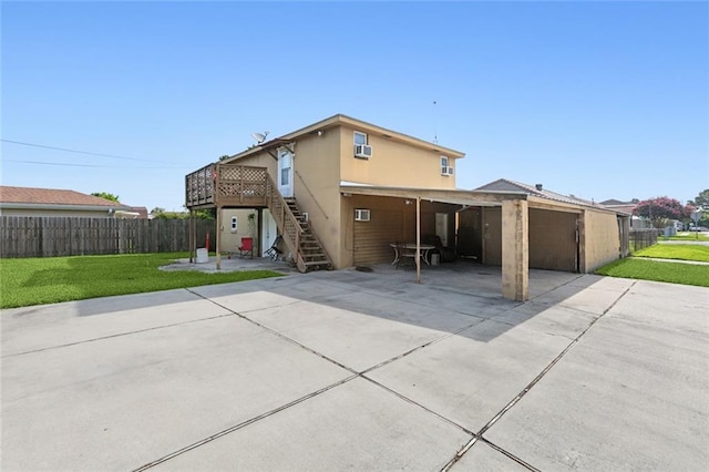 back of house featuring a yard and a carport