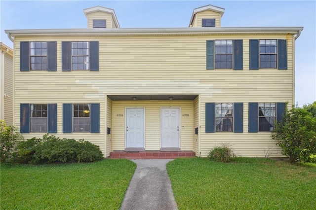 colonial inspired home with a front yard