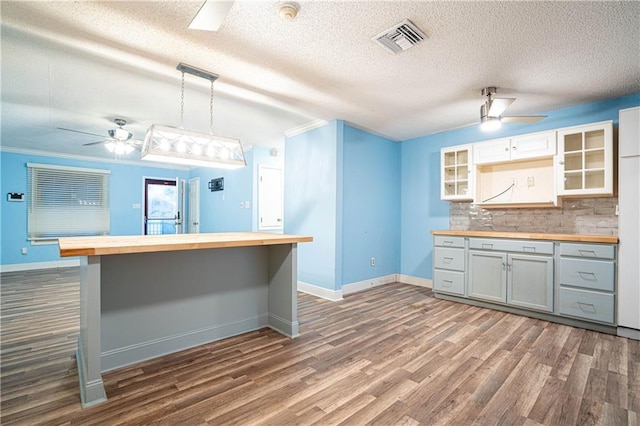 kitchen with gray cabinets, white cabinetry, hanging light fixtures, wood counters, and decorative backsplash