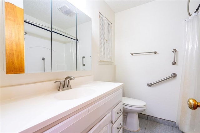 bathroom featuring vanity, toilet, and walk in shower