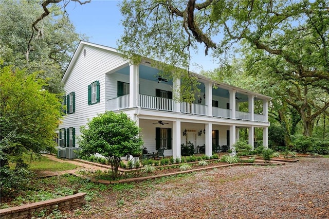 view of front facade featuring cooling unit, ceiling fan, covered porch, and a balcony