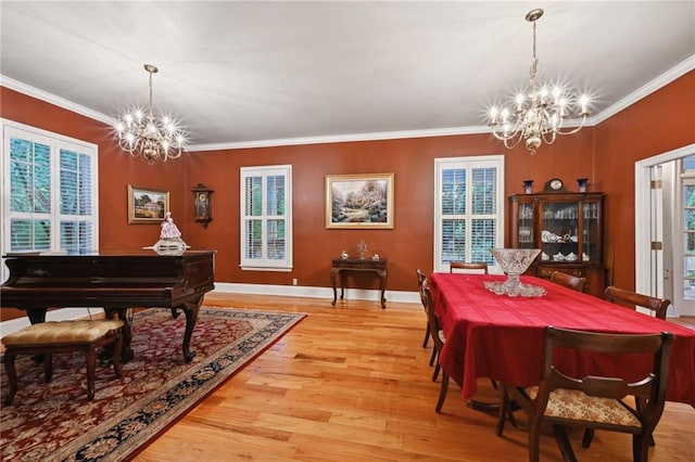 misc room featuring crown molding, a chandelier, and light hardwood / wood-style floors